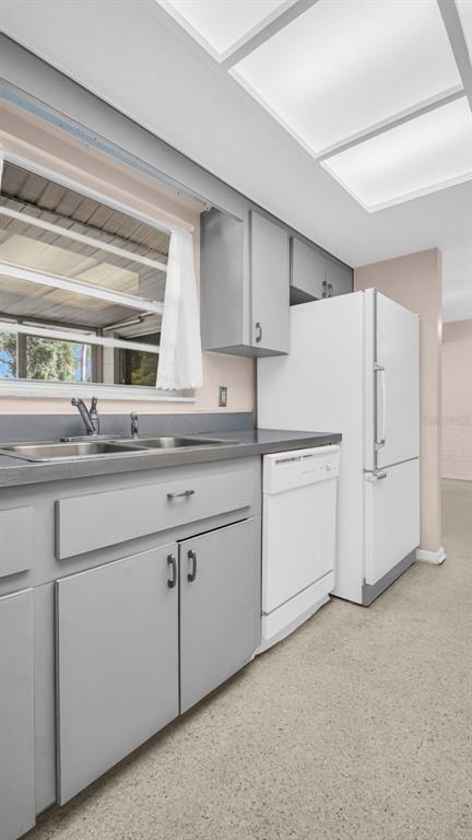 5831 Hillside Street Seminole, FL 33772 - Photo 22 of 26 a kitchen with granite countertop white cabinets and white appliances
