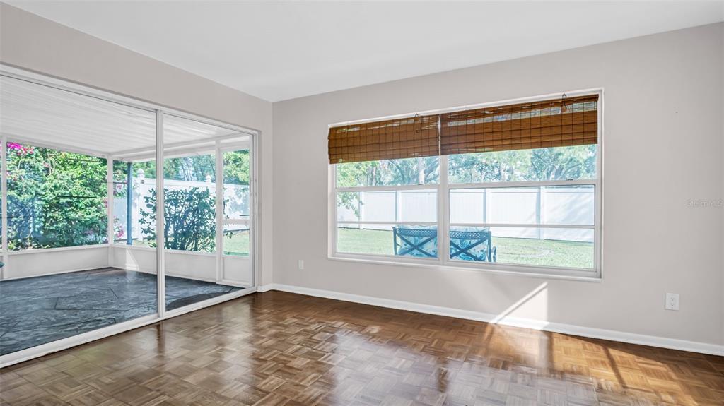 5831 Hillside Street Seminole, FL 33772 - Photo 10 of 26 a view of an empty room with wooden floor and a window