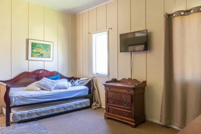a bedroom with furniture and a flat screen tv