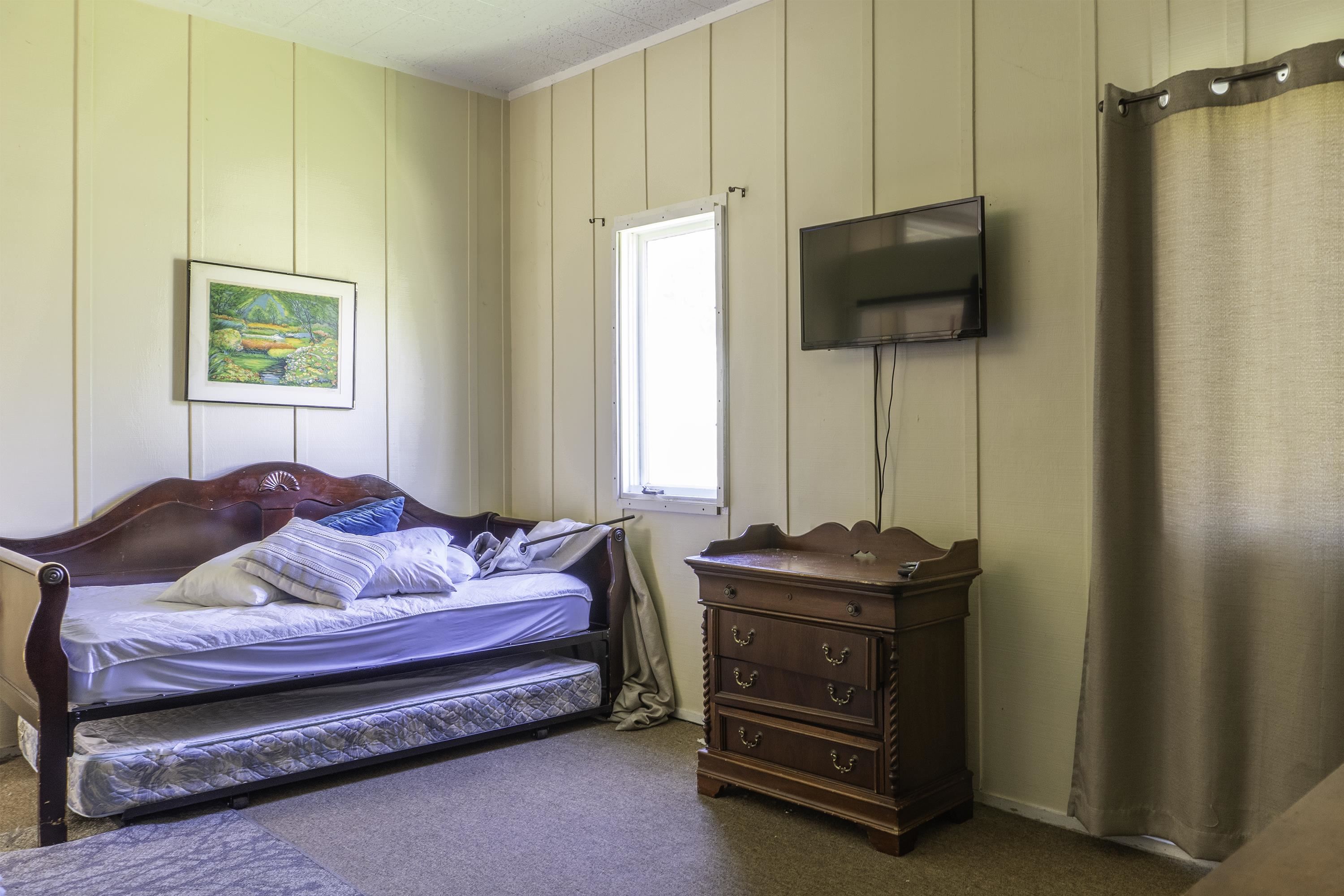 76 Alderman Street June Lake, CA 93529 - Photo 19 of 38 Bedroom featuring a decorative wall and carpet