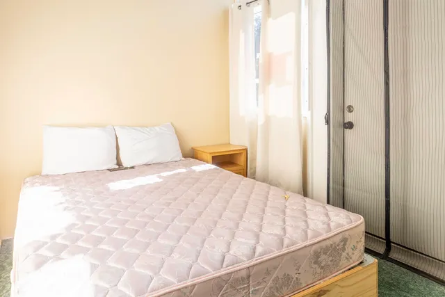 a bedroom with a bed and a mirror