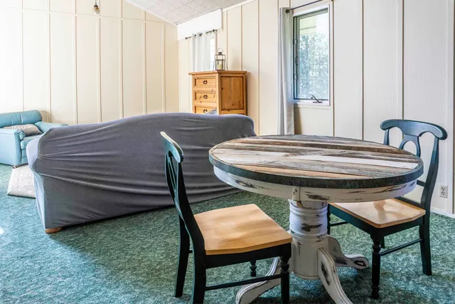 a bed sitting in a room next to a window