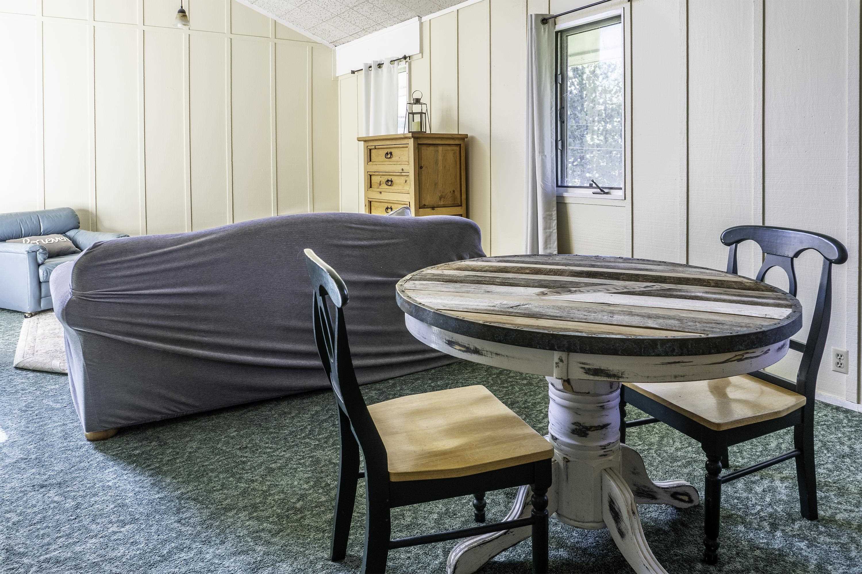 76 Alderman Street June Lake, CA 93529 - Photo 24 of 38 Carpeted dining area with a decorative wall