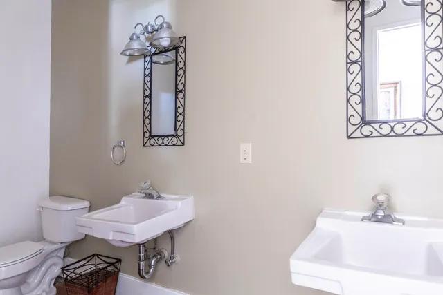 a bathroom with a sink mirror and toilet