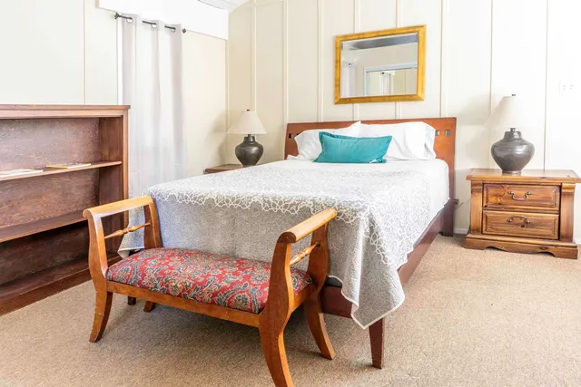 a bedroom with a bed and a window