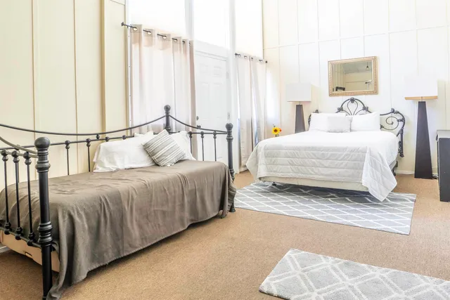 a spacious bedroom with a bed and a window