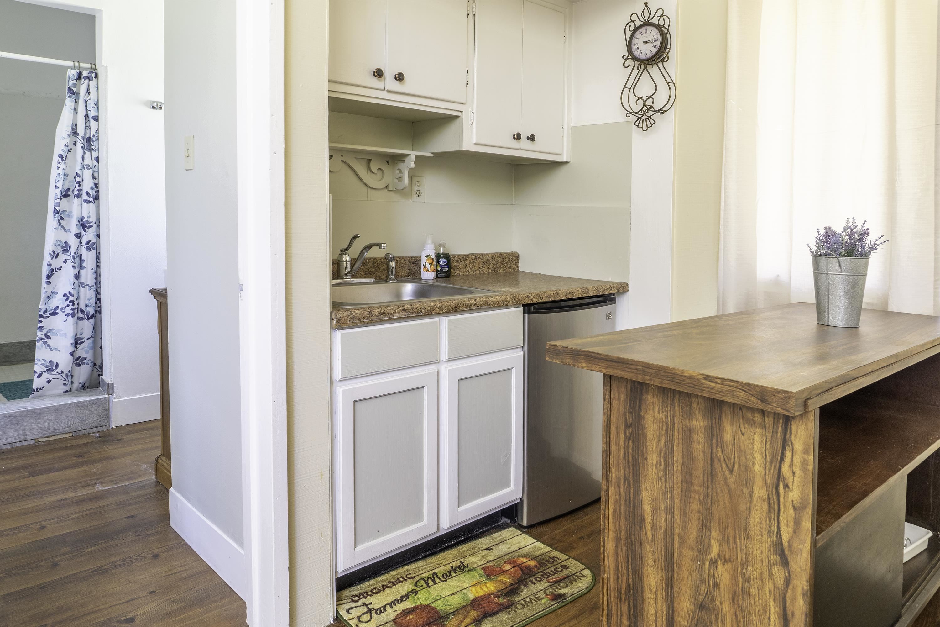 76 Alderman Street June Lake, CA 93529 - Photo 36 of 38 Kitchen featuring dark countertops, dishwasher, dark wood finished floors, and white cabinetry