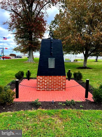 a front view of a house with patio furniture and a fire pit
