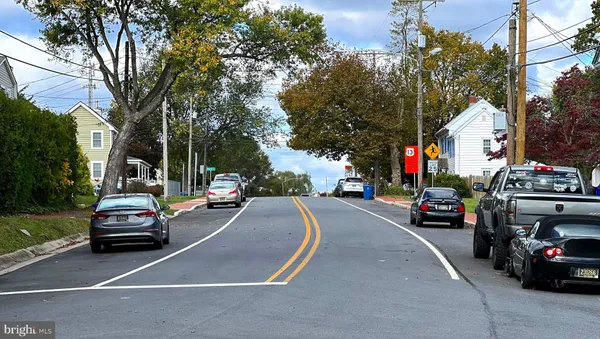 a view of a house with a big garden and trees