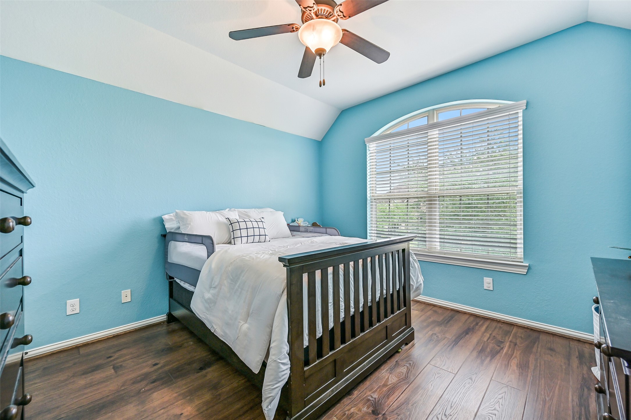 1008 Point Isabel Lane Friendswood, TX 77546 - Photo 43 of 50 The remaining secondary bedroom is highlighted by a palladium arched front facing window that fills the space with natural light, complemented by wood look floors and a clean, neutral finish.