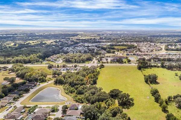 an aerial view of residential building and lake