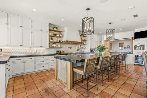 a kitchen with stainless steel appliances granite countertop a sink counter space and cabinets