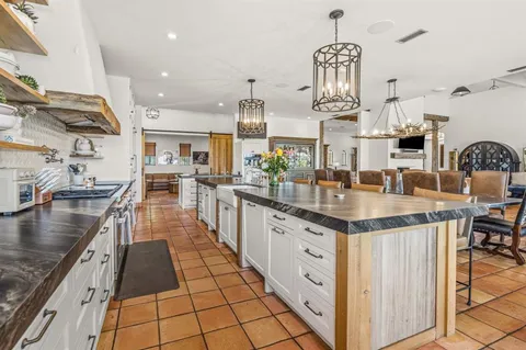 a kitchen with stainless steel appliances granite countertop a stove and a sink