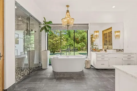 a spacious bathroom with a double vanity sink a large mirror and a bathtub