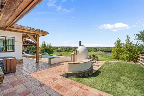 a swimming pool with outdoor seating and yard