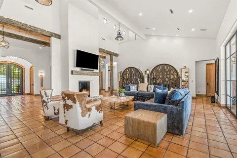 a living room with fireplace furniture and a flat screen tv