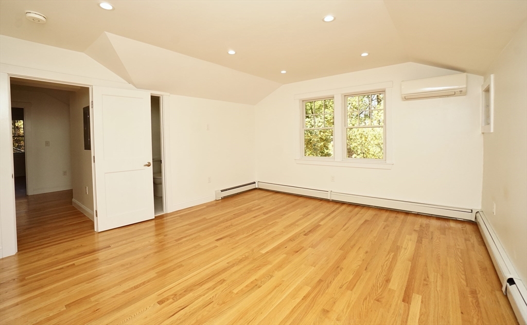 2 Thaxter Road Newton, MA 02460 - Photo 25 of 36 a view of an empty room with wooden floor and a window