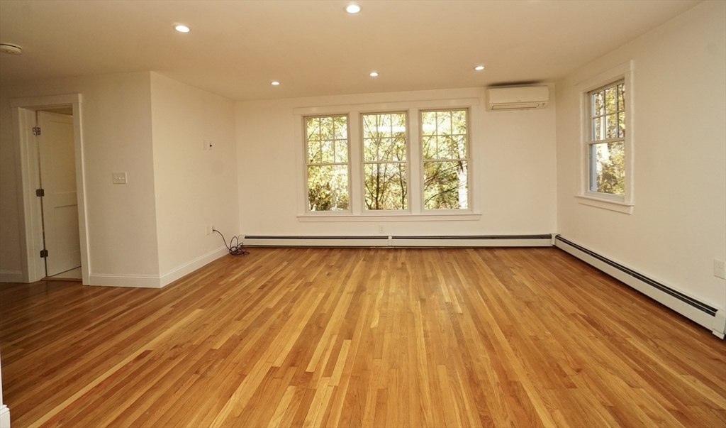 2 Thaxter Road Newton, MA 02460 - Photo 3 of 36 an empty room with wooden floor and windows