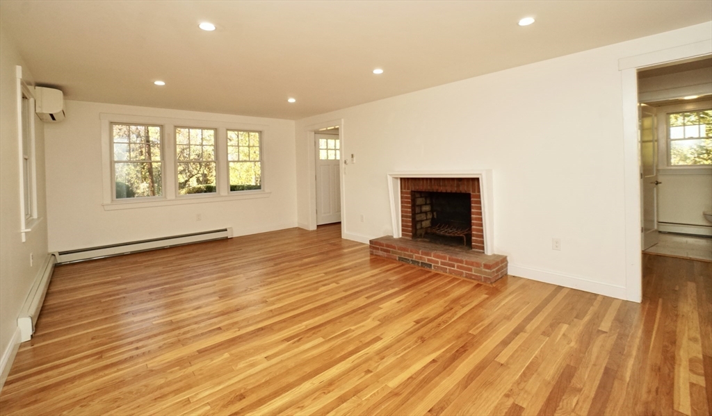 2 Thaxter Road Newton, MA 02460 - Photo 8 of 36 a view of an empty room with wooden floor and a window