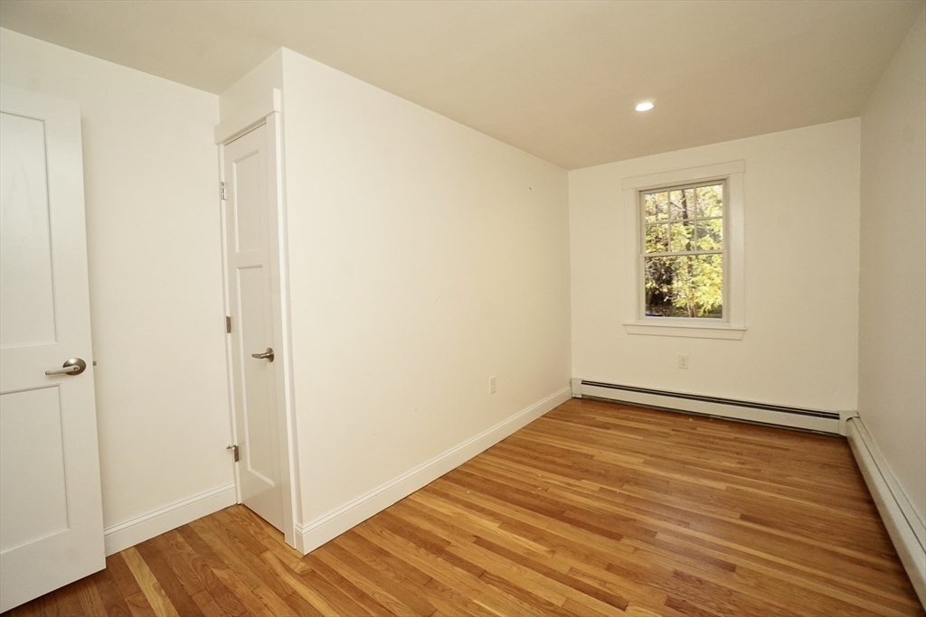 2 Thaxter Road Newton, MA 02460 - Photo 9 of 36 a view of an empty room with wooden floor