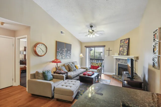 a living room with fireplace furniture and a fireplace