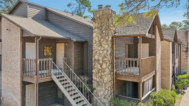 a front view of a house with iron stairs