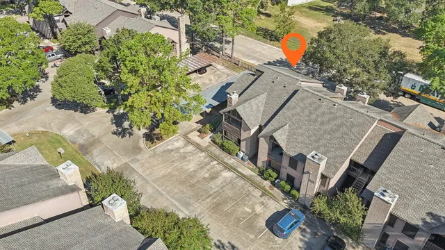 an aerial view of a house with a yard and garden