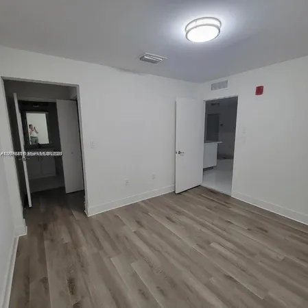 a view of an empty room with a fireplace