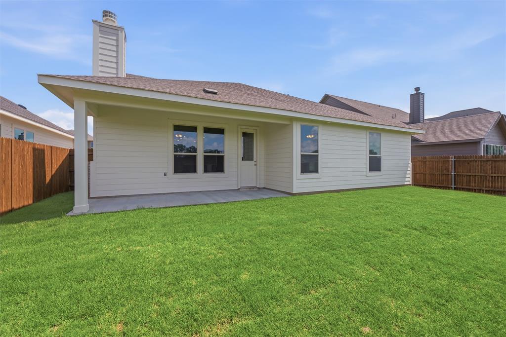 1232 Colca Drive Springtown, TX 76082 - Photo 20 of 23 Expansive green lawn with a covered concrete patio