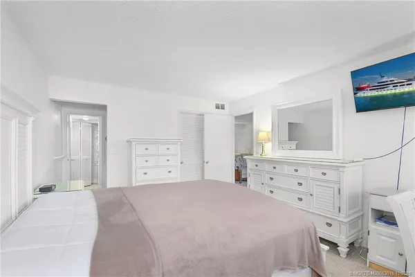 a bedroom with a bed and a dresser