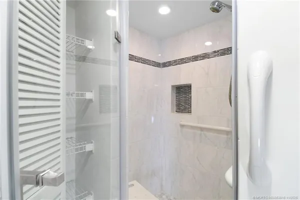 a bathroom with a shower and a glass door