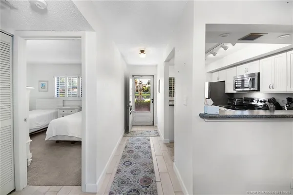 a view of a bedroom with furniture and window