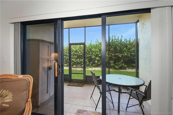 a view of a balcony with a table and chairs