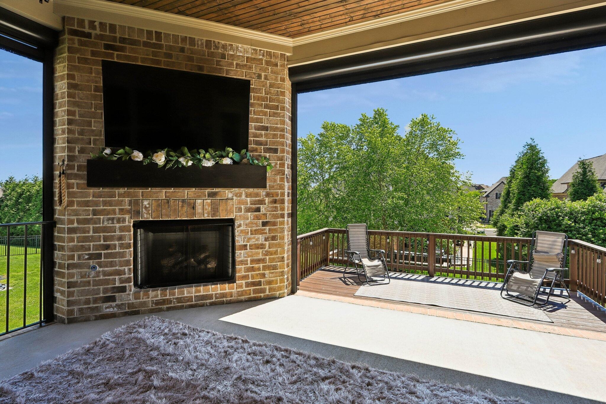 1006 Alpaca Drive Spring Hill, TN 37174 - Photo 26 of 32 a view of a patio with a table and a fire pit