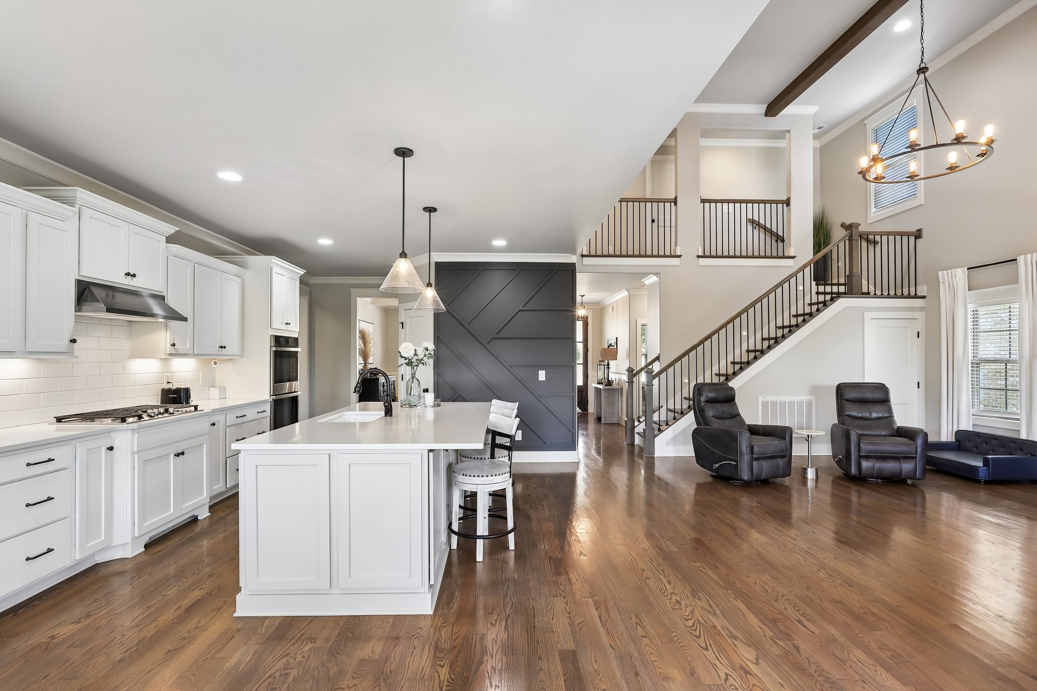 1006 Alpaca Drive Spring Hill, TN 37174 - Photo 6 of 32 a kitchen with stainless steel appliances kitchen island granite countertop a stove a sink a refrigerator and a dining table with wooden floor