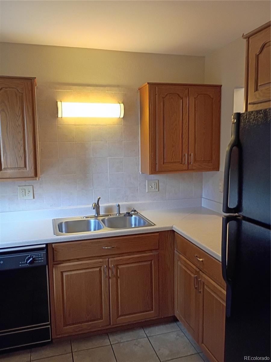 1625 West Elizabeth Street, Unit A1 Fort Collins, CO 80521 - Photo 11 of 27 a kitchen with a sink and refrigerator