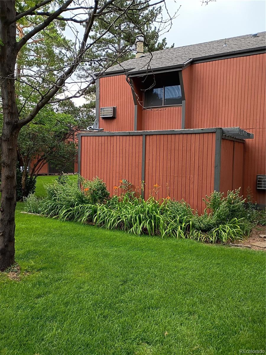 1625 West Elizabeth Street, Unit A1 Fort Collins, CO 80521 - Photo 2 of 27 a view of a backyard with plants and large trees