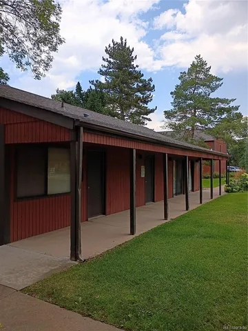 a view of a street with couches and a table
