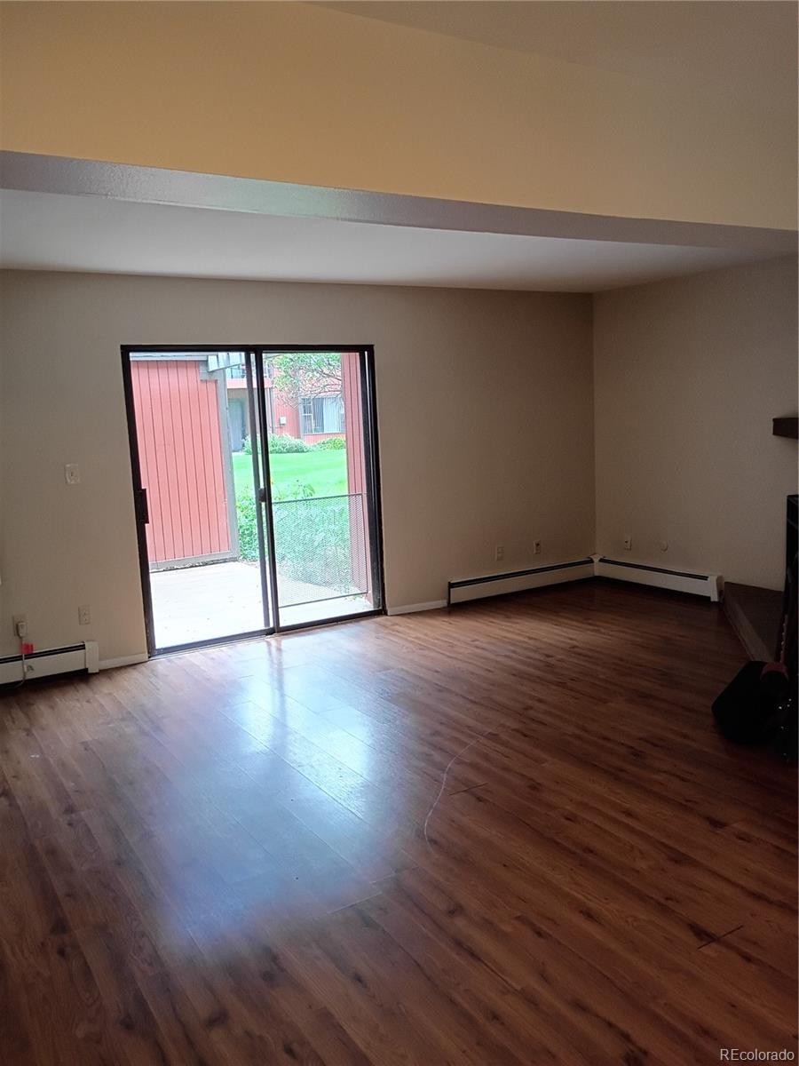 1625 West Elizabeth Street, Unit A1 Fort Collins, CO 80521 - Photo 4 of 27 an empty room with wooden floor and windows