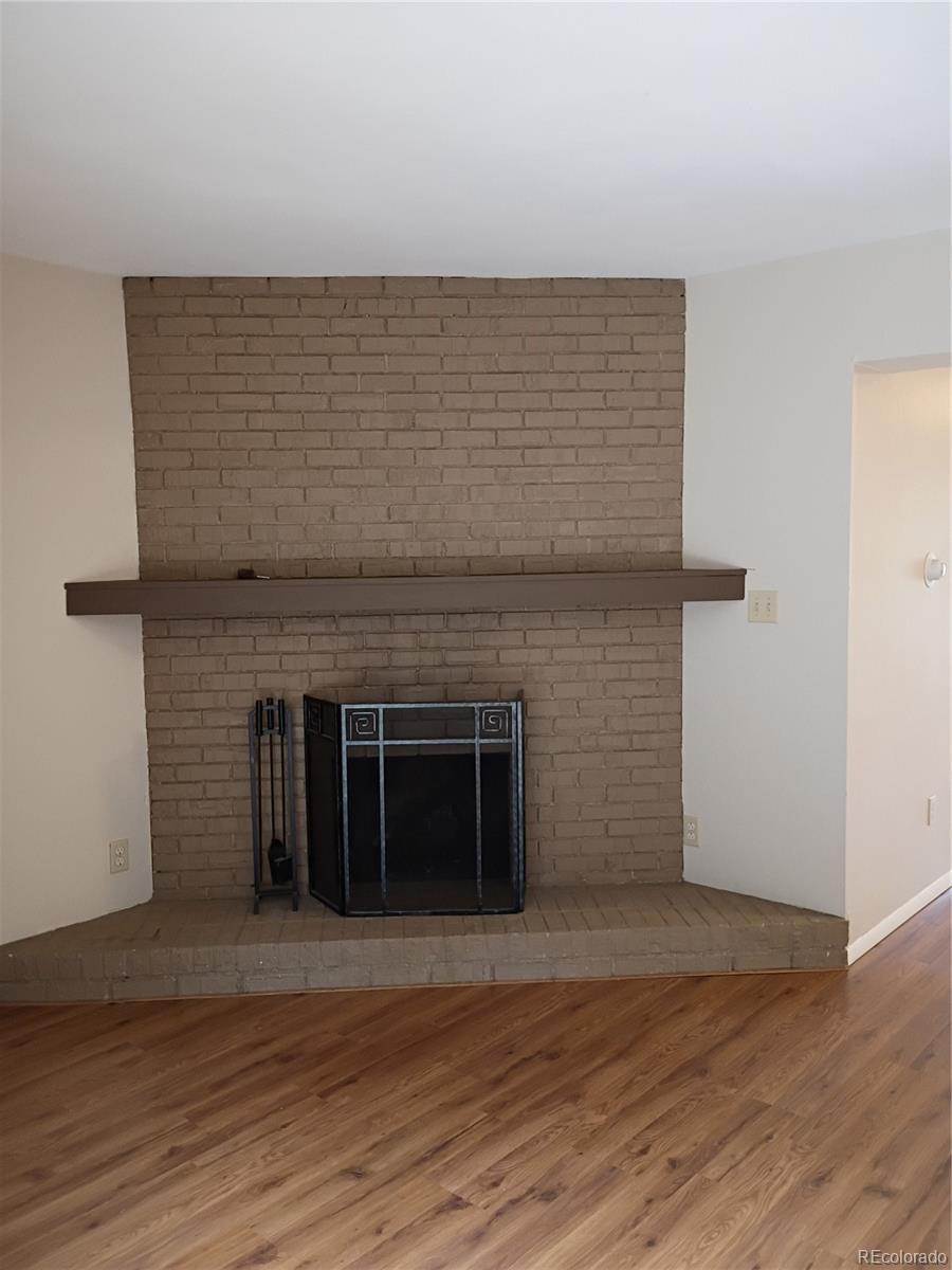 1625 West Elizabeth Street, Unit A1 Fort Collins, CO 80521 - Photo 5 of 27 a view of an empty room with wooden floor and a fireplace