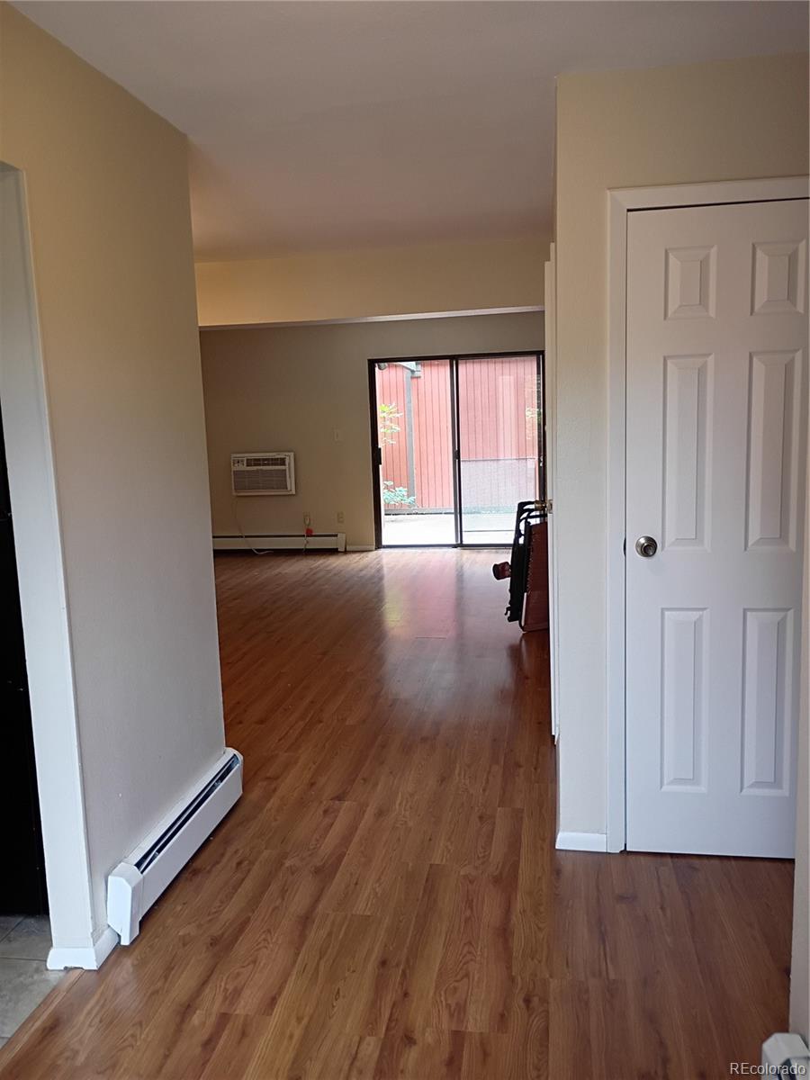 1625 West Elizabeth Street, Unit A1 Fort Collins, CO 80521 - Photo 6 of 27 an empty room with wooden floor and a window