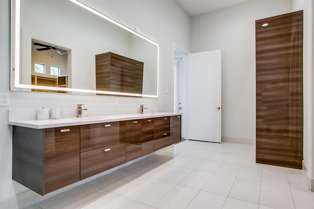 6319 Turner Way Dallas, TX 75230 - Photo 19 of 40 a spacious bathroom with a double vanity sink a mirror and a shower