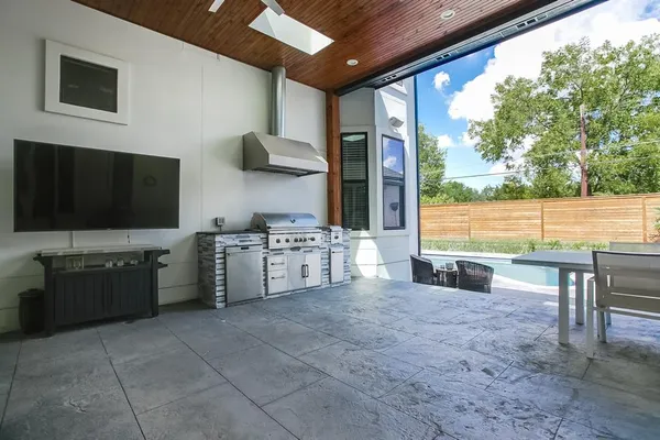 a large white kitchen with a large window