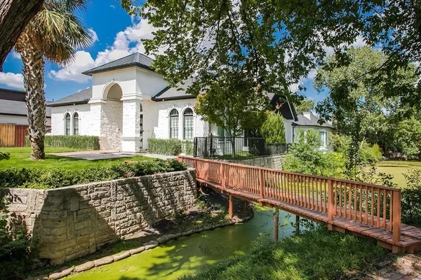 a view of a house with wooden fence