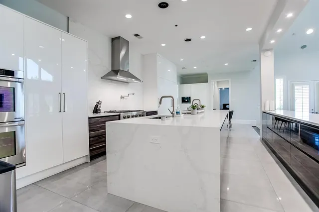 a kitchen with stainless steel appliances granite countertop a sink and a refrigerator