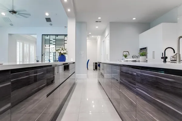 a large kitchen with kitchen island a sink stainless steel appliances and a counter space