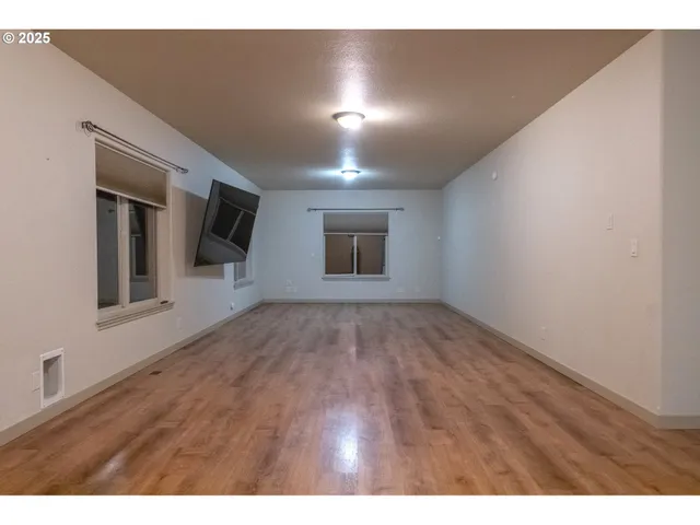 a view of an empty room with closet and a window