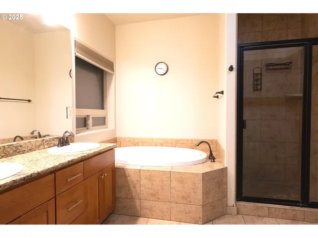a bathroom with a granite countertop sink mirror and toilet