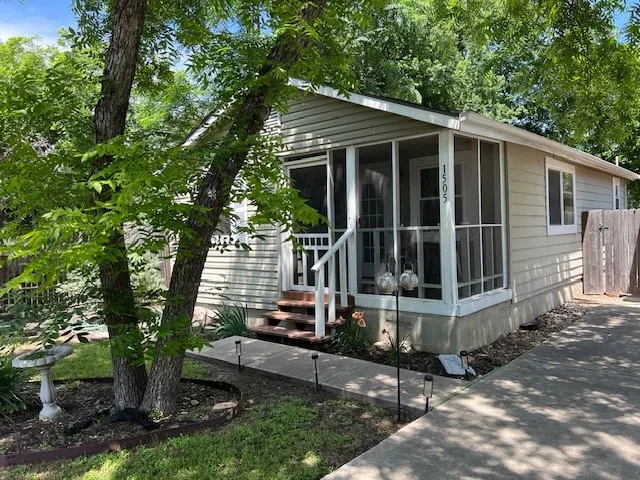 a view of a house with backyard and sitting area