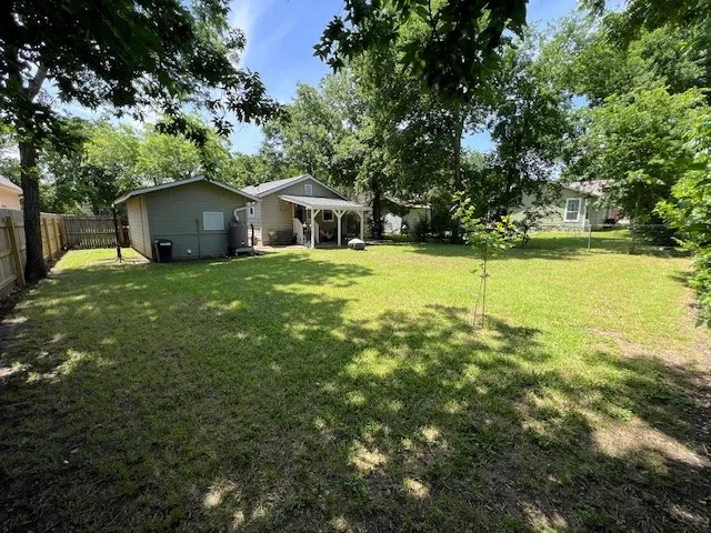 a view of a house with a yard patio and swimming pool